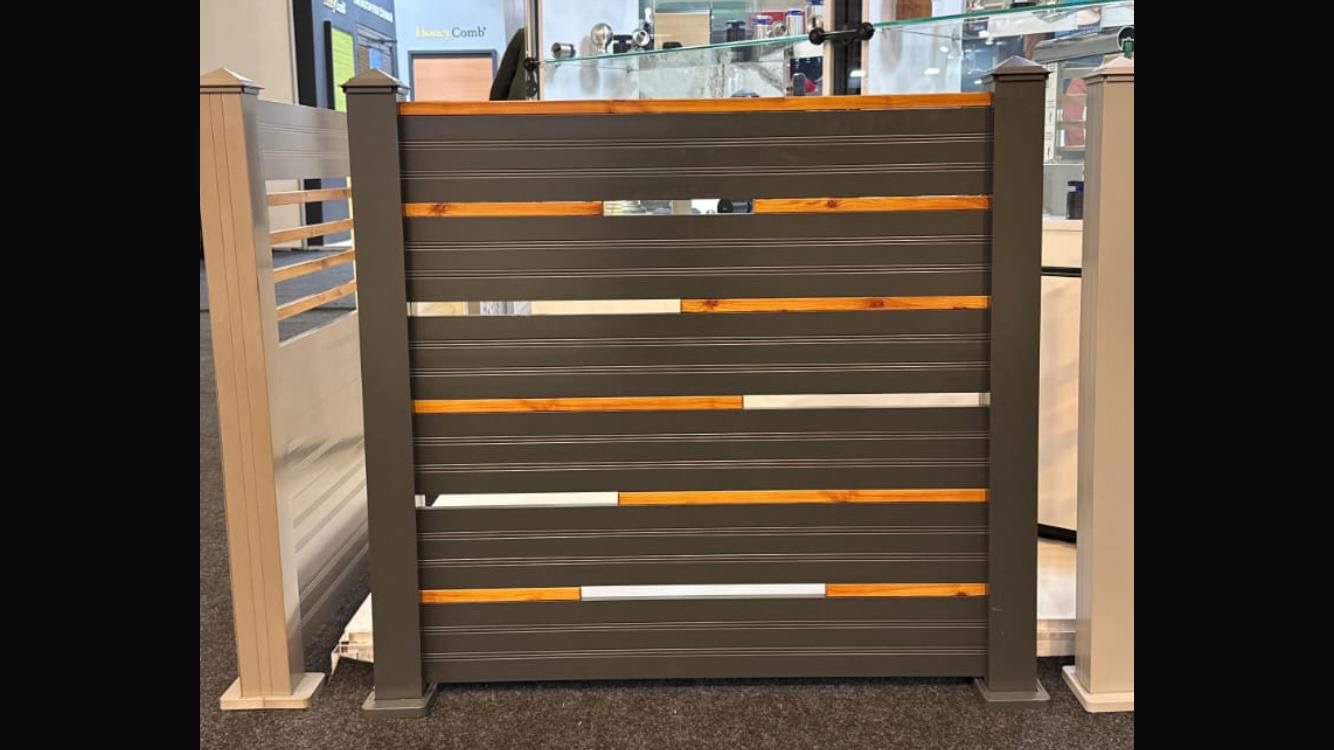 Modern full-privacy horizontal slat fence, dark gray panels and black posts