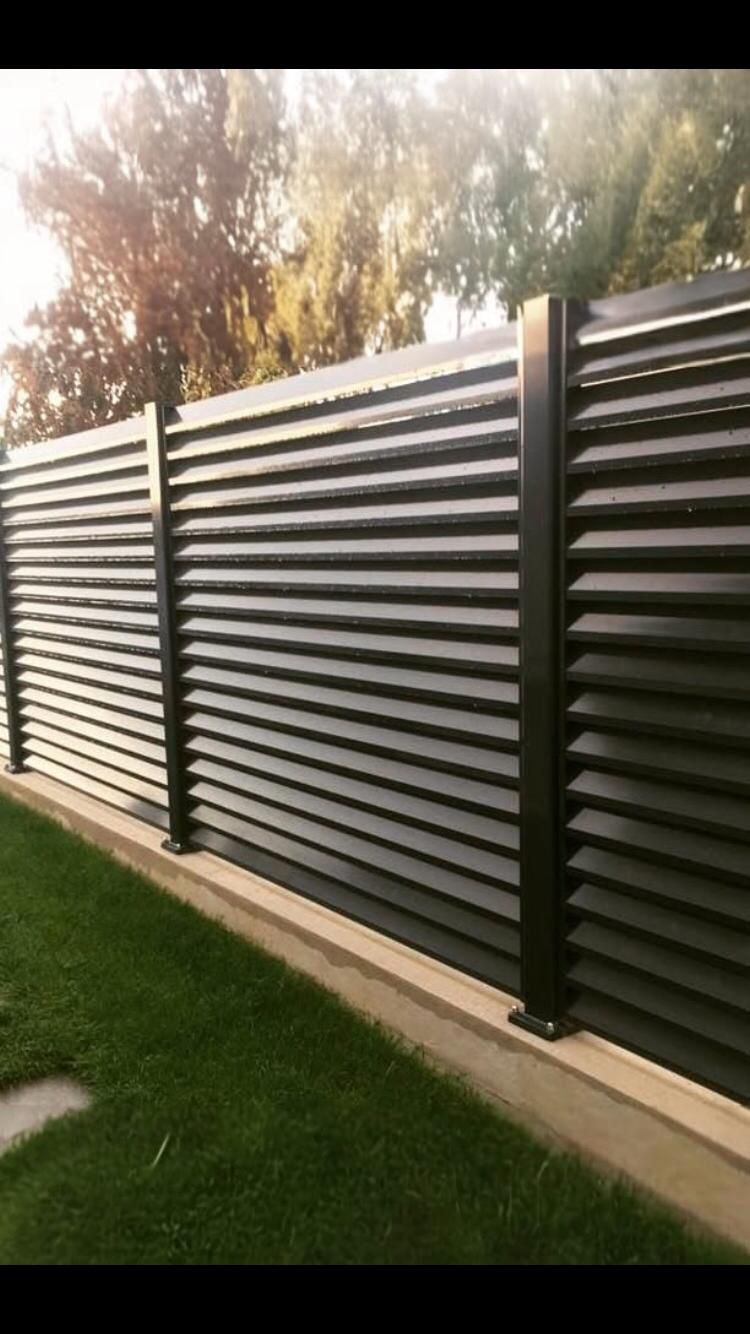 Anthracite louvered sliding gate at property entrance