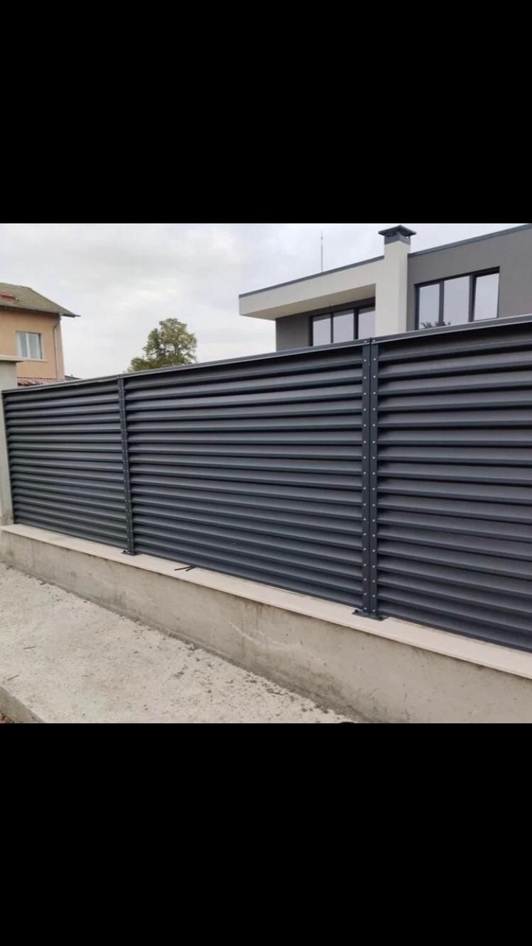 Modern three-panel louvered sliding gate on track