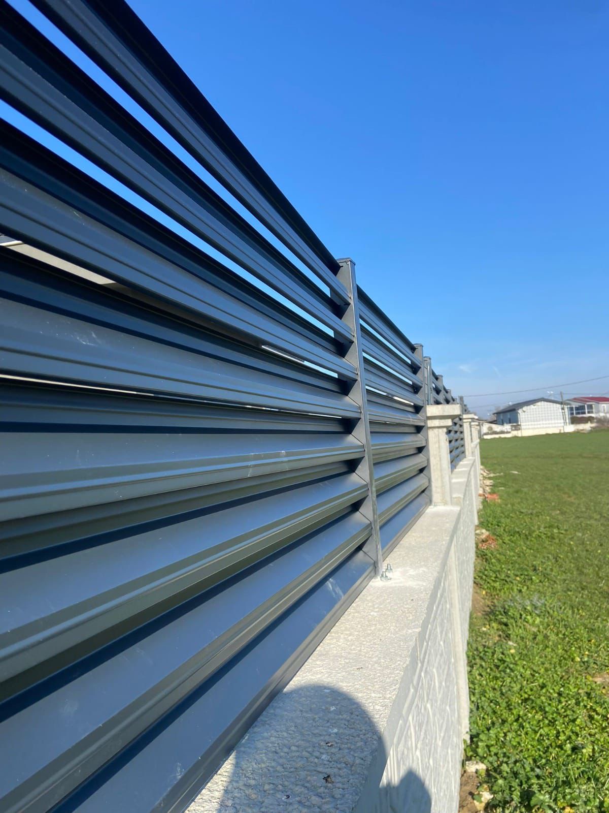 Luxury home with glass railing and stone cladding