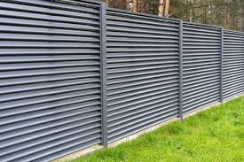Horizontal slat aluminum fence with lawn and trees