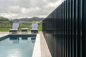 Black vertical slat fence beside pool
